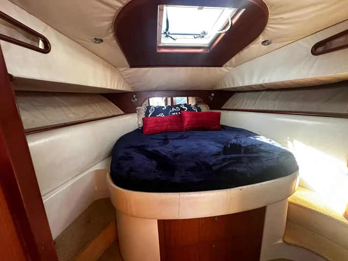  Yacht Photos Pics Luxurious cabin interior of 2006 Chris-Craft 43 Roamer with skylight and plush bedding.