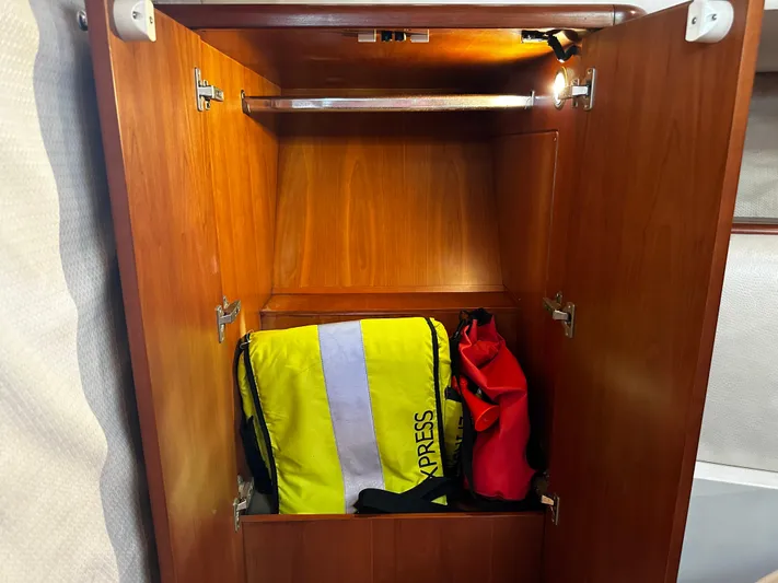  Yacht Photos Pics Open wooden cabinet on 2006 Chris-Craft 43 Roamer with bags inside.