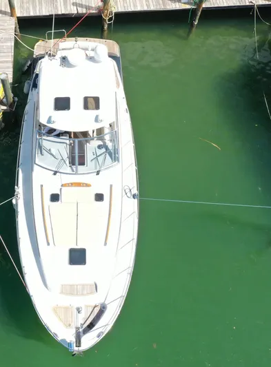  Yacht Photos Pics 2006 Chris-Craft 43 Roamer yacht docked in green water, aerial view.
