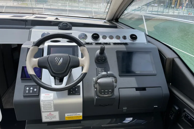  Yacht Photos Pics Cockpit of 2021 Fairline Targa 45 GT with steering wheel and navigation controls.
