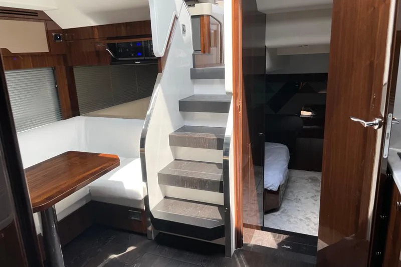  Yacht Photos Pics Interior of 2021 Fairline Targa 45 GT yacht with modern wood finishes and cozy seating area.