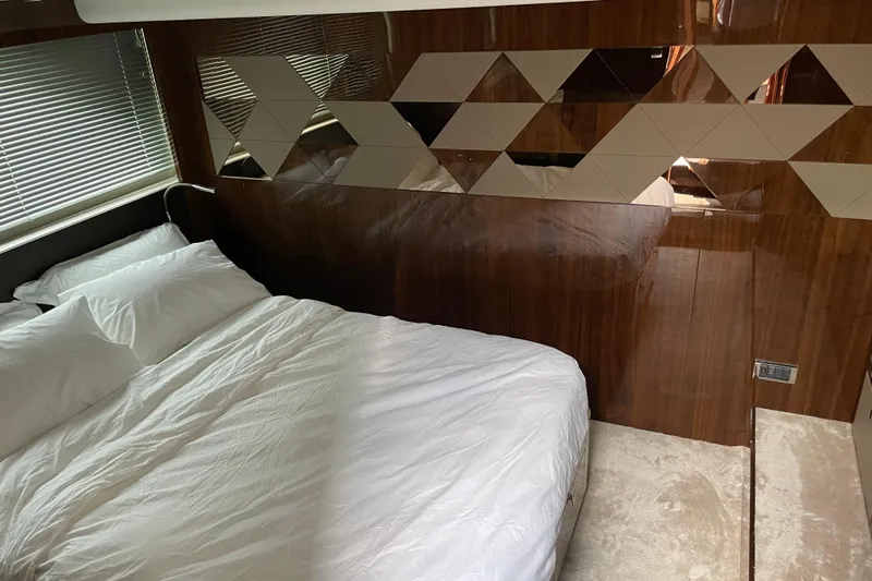  Yacht Photos Pics Luxurious bedroom interior of 2021 Fairline Targa 45 GT yacht with geometric wall design.