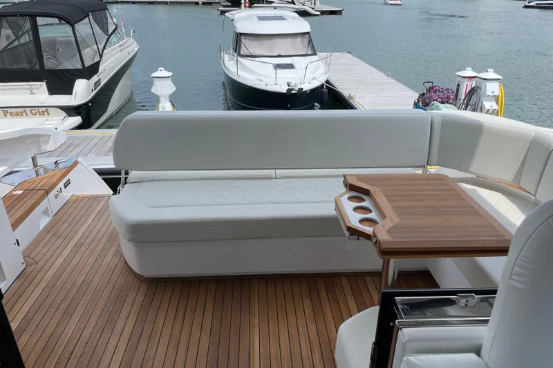  Yacht Photos Pics Fairline Targa 45 GT 2021 yacht with elegant seating and wooden table on deck.