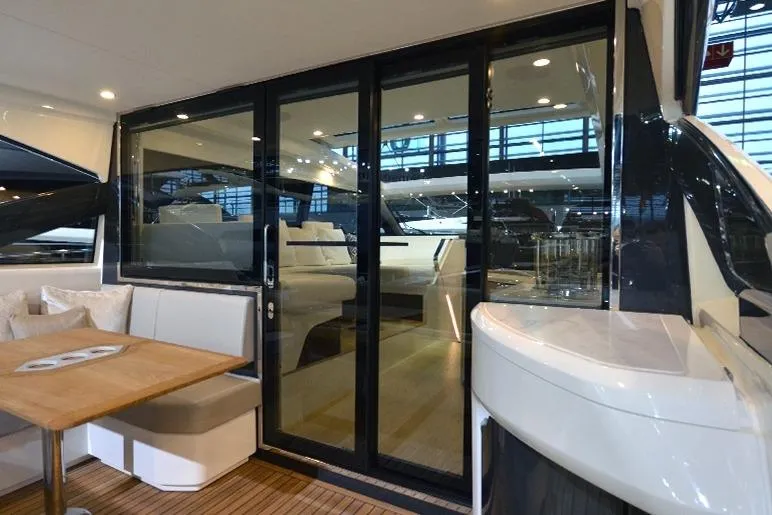  Yacht Photos Pics 2021 Fairline Targa 45 GT yacht interior with sliding glass doors and seating area.