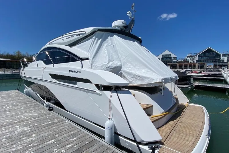  Yacht Photos Pics 2021 Fairline Targa 45 GT yacht docked at marina under clear blue sky.