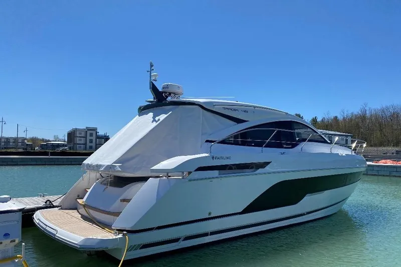  Yacht Photos Pics 2021 Fairline Targa 45 GT yacht docked in a marina under clear blue sky.
