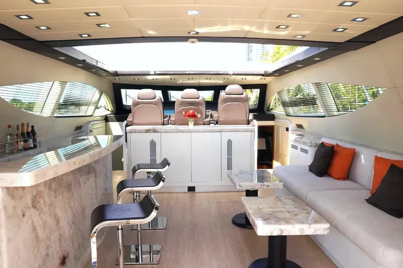 Daya Yacht Photos Pics Luxurious interior of a 2007 Mangusta 105 yacht with modern seating and bar area.