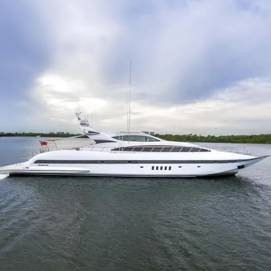 Daya Yacht Photos Pics 2007 Mangusta 105 yacht cruising on calm waters under a cloudy sky.