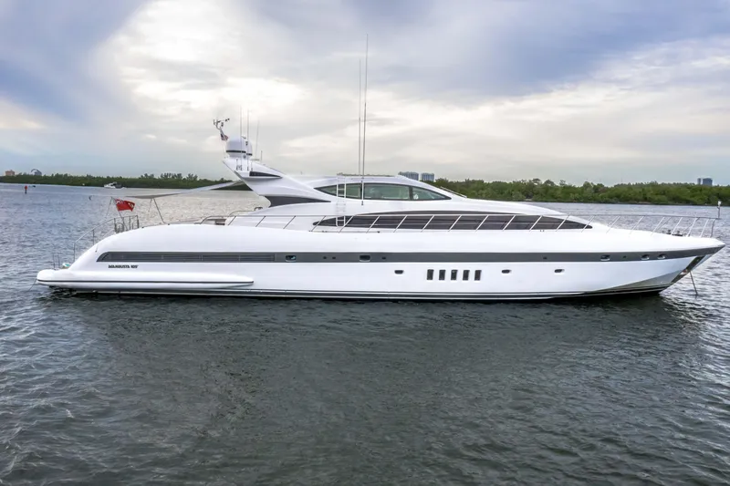 Daya Yacht Photos Pics Luxury 2007 Mangusta 105 yacht on calm water under a cloudy sky.