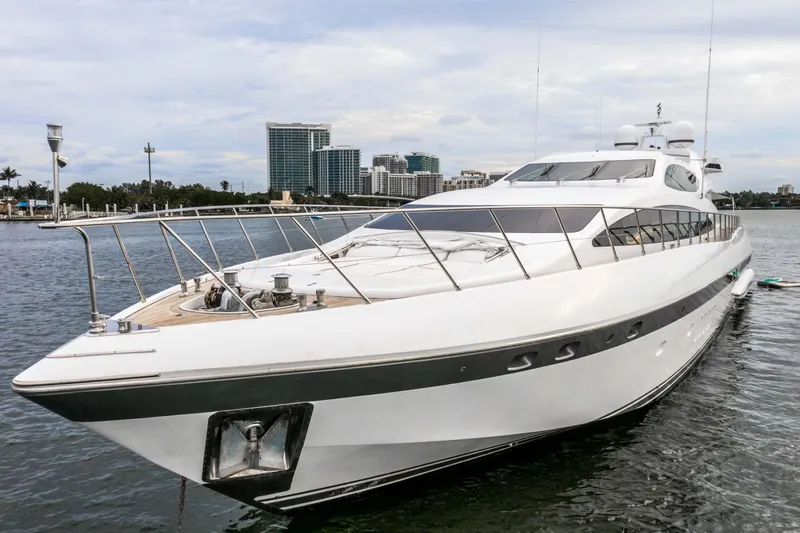 Daya Yacht Photos Pics Luxurious 2007 Mangusta 105 yacht docked with city skyline backdrop.
