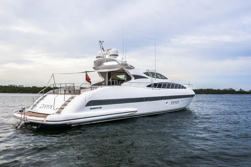 Daya Yacht Photos Pics Luxury 2007 Mangusta 105 yacht on calm waters, showcasing sleek design and elegance.