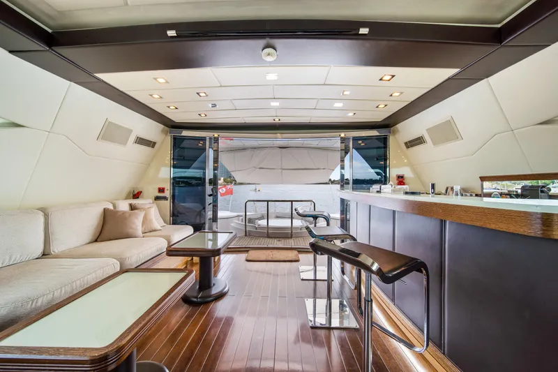 Daya Yacht Photos Pics Luxurious interior of 2007 Mangusta 105 yacht with elegant seating and bar area.