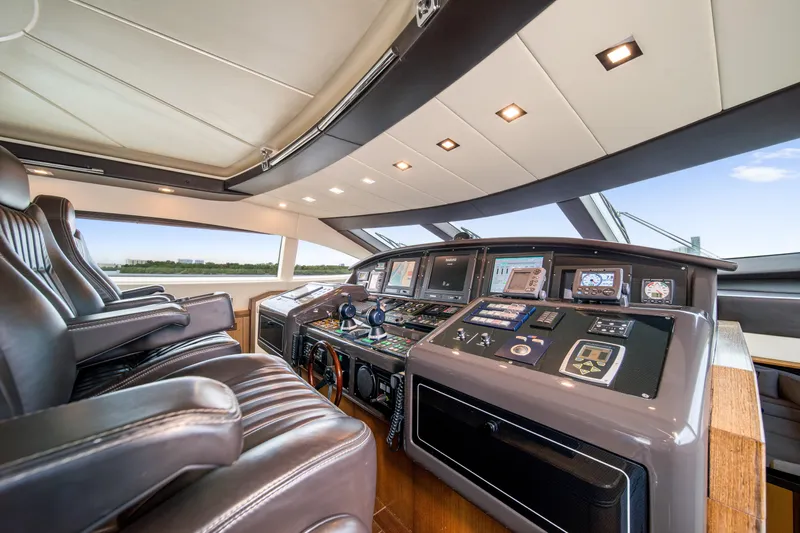 Daya Yacht Photos Pics Luxurious 2007 Mangusta 105 yacht cockpit with advanced navigation controls and leather seating.