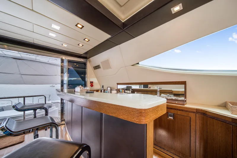 Daya Yacht Photos Pics Luxurious interior of 2007 Mangusta 105 yacht with modern bar and ocean view.