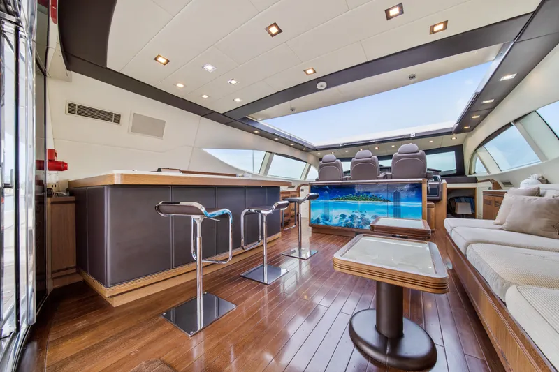 Daya Yacht Photos Pics Luxurious interior of 2007 Mangusta 105 yacht with modern seating and panoramic windows.