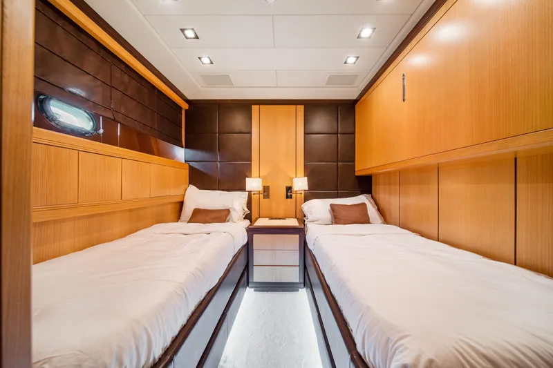 Daya Yacht Photos Pics Luxurious twin cabin interior of 2007 Mangusta 105 yacht with modern wood paneling.