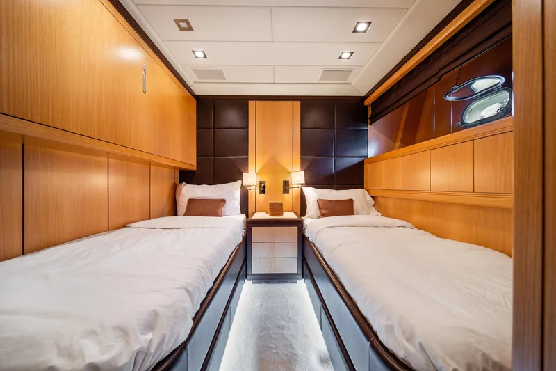 Daya Yacht Photos Pics Luxurious twin cabin interior of 2007 Mangusta 105 yacht with modern wood paneling.