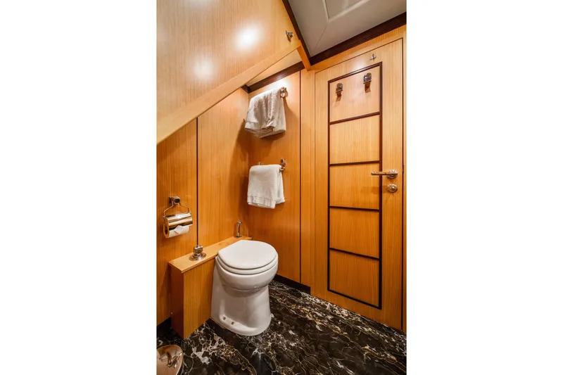 Daya Yacht Photos Pics Luxurious 2007 Mangusta 105 yacht bathroom with wood paneling and marble flooring.