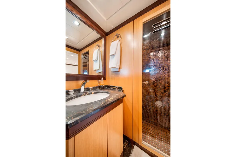 Daya Yacht Photos Pics Luxurious bathroom in 2007 Mangusta 105 yacht with marble countertop and mosaic-tiled shower.
