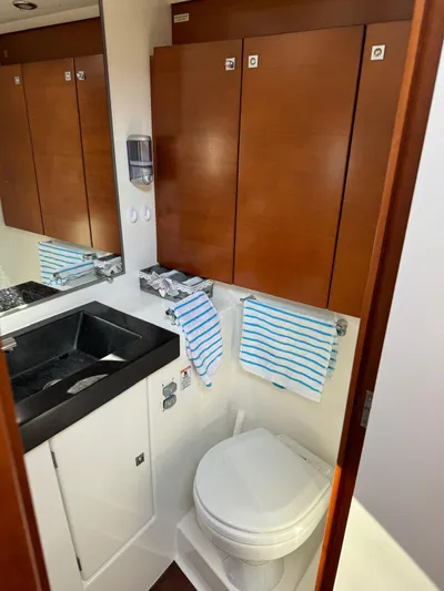  Yacht Photos Pics Bathroom interior of 2010 Dufour 45E Performance yacht with wooden cabinets and modern fixtures.