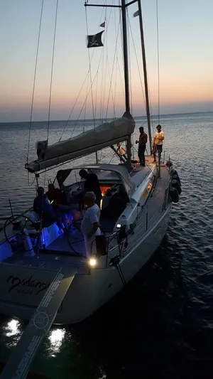  Yacht Photos Pics Sailing yacht Dufour 45E Performance 2010 at sunset with people on deck.