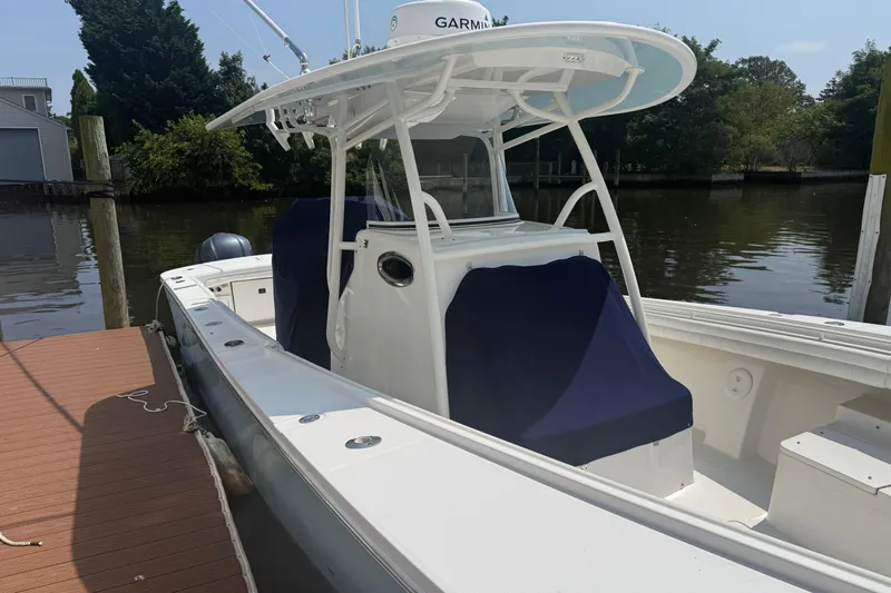 Yacht Photos Pics 2018 Regulator 31 boat docked, featuring a Garmin system and covered seating.