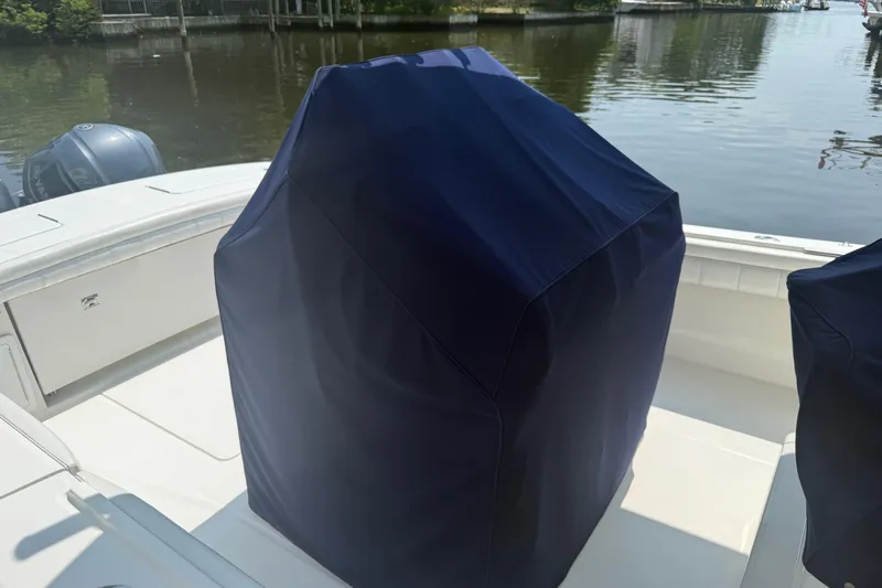  Yacht Photos Pics 2018 Regulator 31 boat with covered seating, docked by calm waters.