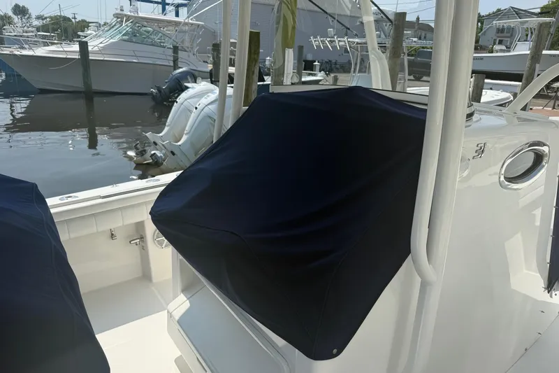  Yacht Photos Pics 2018 Regulator 31 boat with covered console, docked near other vessels.