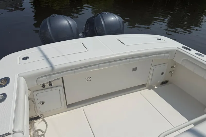 Yacht Photos Pics 2018 Regulator 31 boat deck with dual outboard motors on calm water.