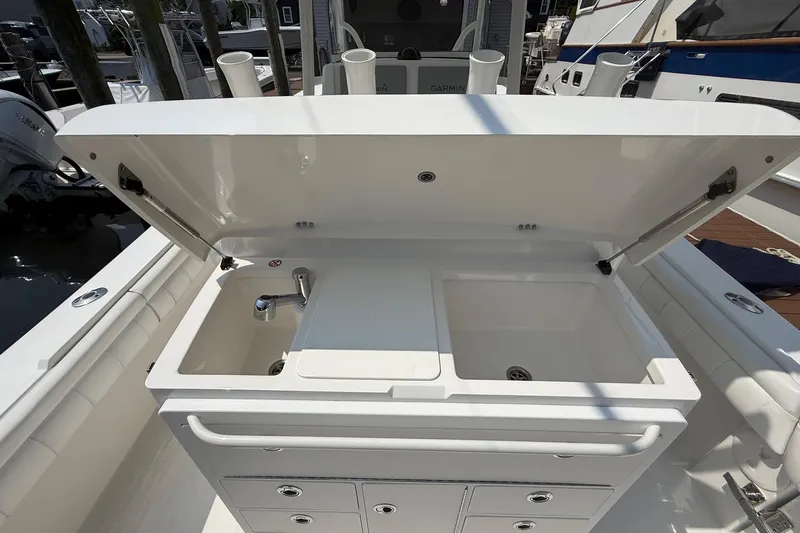  Yacht Photos Pics Open storage compartment with sink on a 2018 Regulator 31 boat.