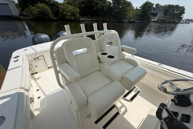  Yacht Photos Pics 2018 Regulator 31 boat interior with dual white captain's chairs and water view.