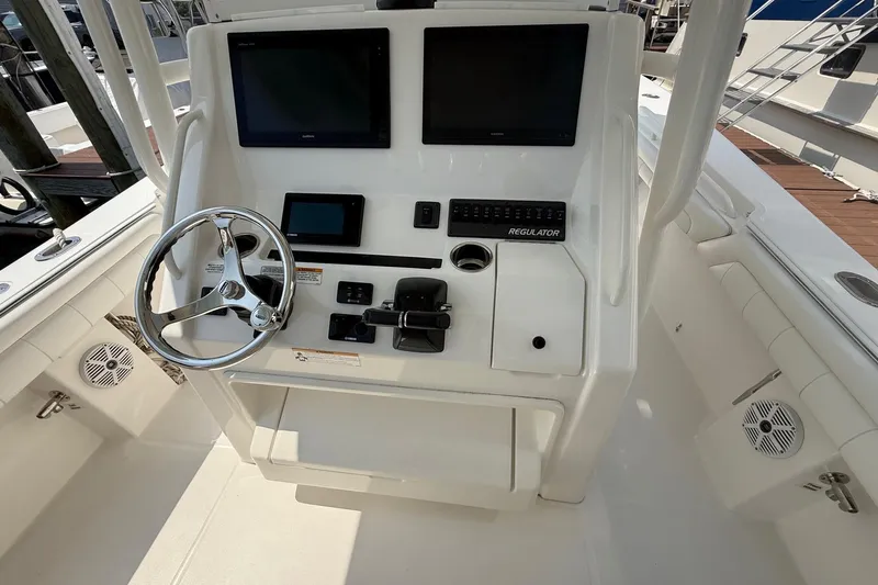  Yacht Photos Pics 2018 Regulator 31 boat console with steering wheel and electronic displays.