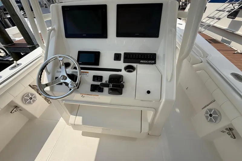  Yacht Photos Pics 2018 Regulator 31 boat helm with dual screens and steering wheel.