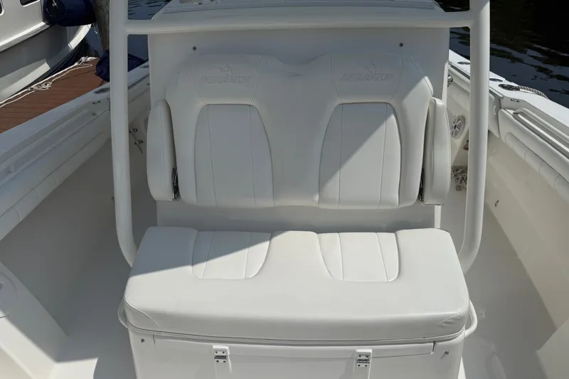  Yacht Photos Pics 2018 Regulator 31 boat with white cushioned seating and storage compartment.