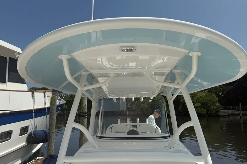  Yacht Photos Pics 2018 Regulator 31 boat with T-top, docked near other vessels.