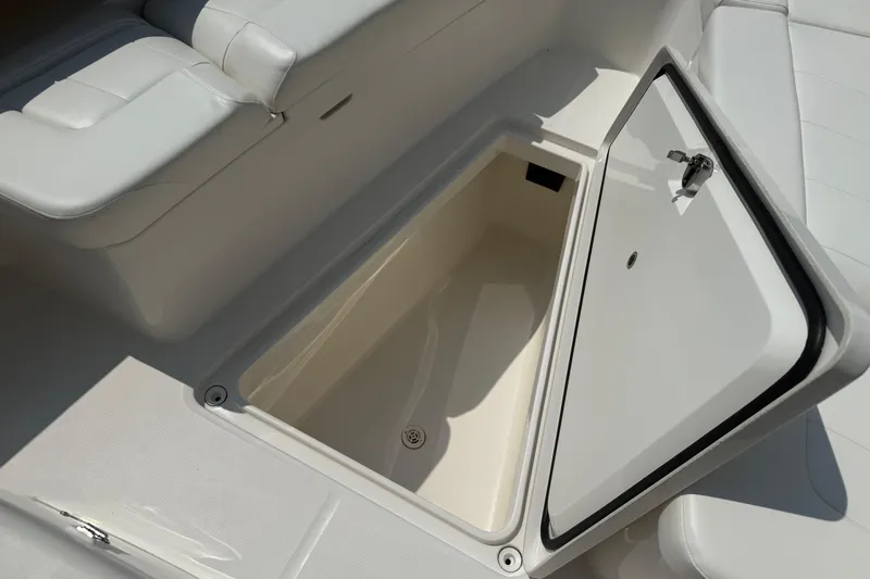  Yacht Photos Pics Open storage compartment on 2018 Regulator 31 boat with cushioned seating.