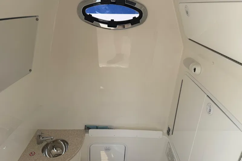  Yacht Photos Pics Interior of 2018 Regulator 31 boat cabin with sink and porthole.