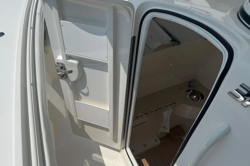  Yacht Photos Pics 2018 Regulator 31 boat cabin interior with open door and visible sink.