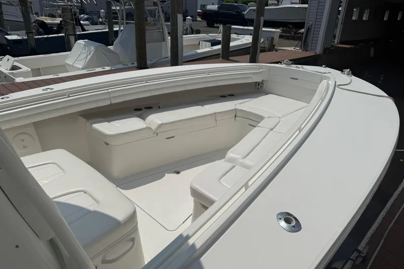  Yacht Photos Pics 2018 Regulator 31 boat with spacious white seating area at a marina.