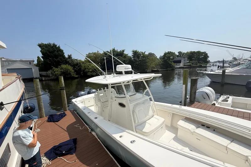  Yacht Photos Pics 2018 Regulator 31 boat docked at marina with person handling ropes.