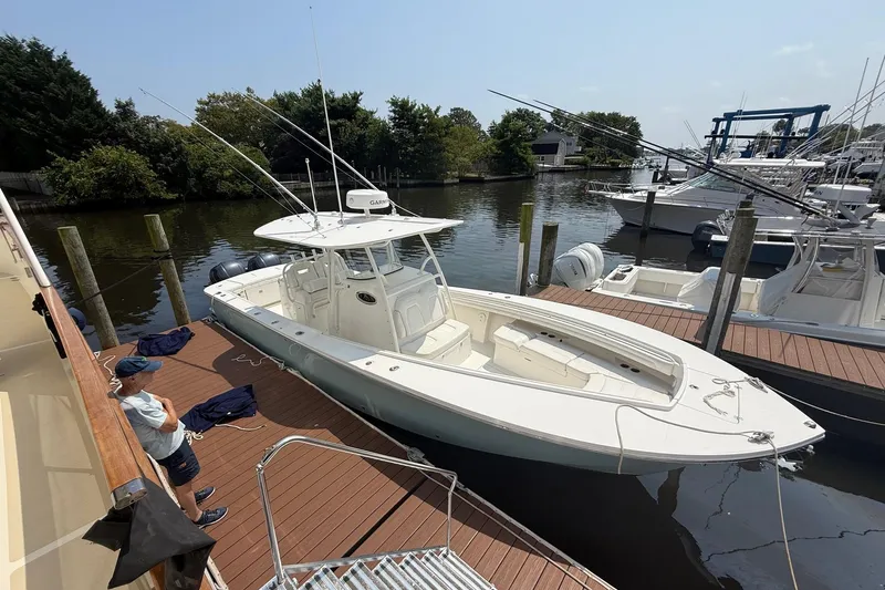  Yacht Photos Pics 2018 Regulator 31 boat docked at marina, surrounded by other vessels and greenery.
