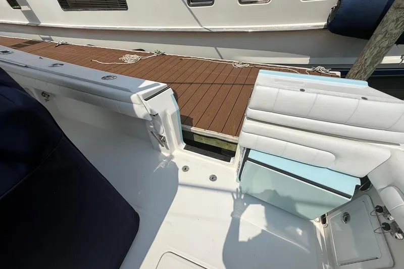  Yacht Photos Pics 2018 Regulator 31 boat interior with white seating and dock view.