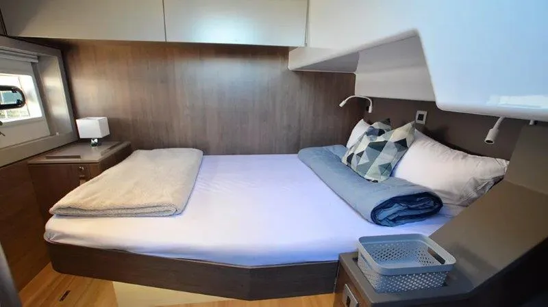 Neve Yacht Photos Pics Cozy bedroom in 2022 Bali 4.6 yacht with modern decor and comfortable bedding.