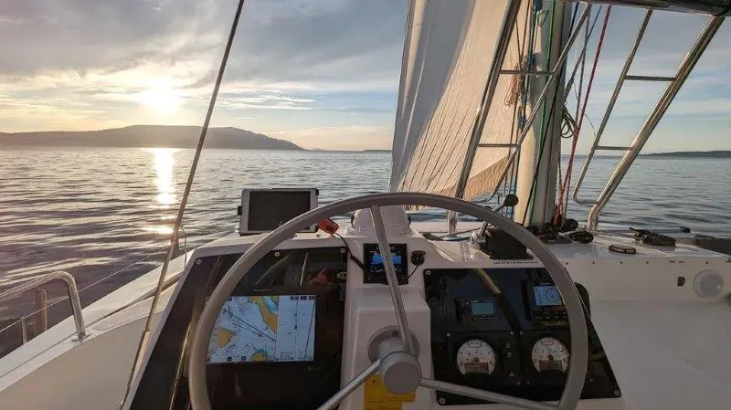 Neve Yacht Photos Pics Sailing on a Bali 4.6 yacht at sunset, 2022 model, with navigational equipment visible.
