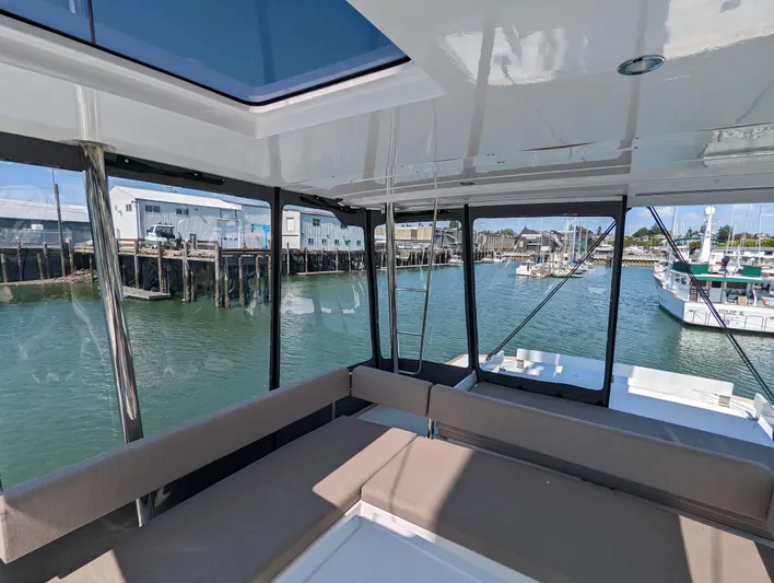 Neve Yacht Photos Pics Interior view of 2022 Bali 4.6 catamaran with waterfront marina backdrop.