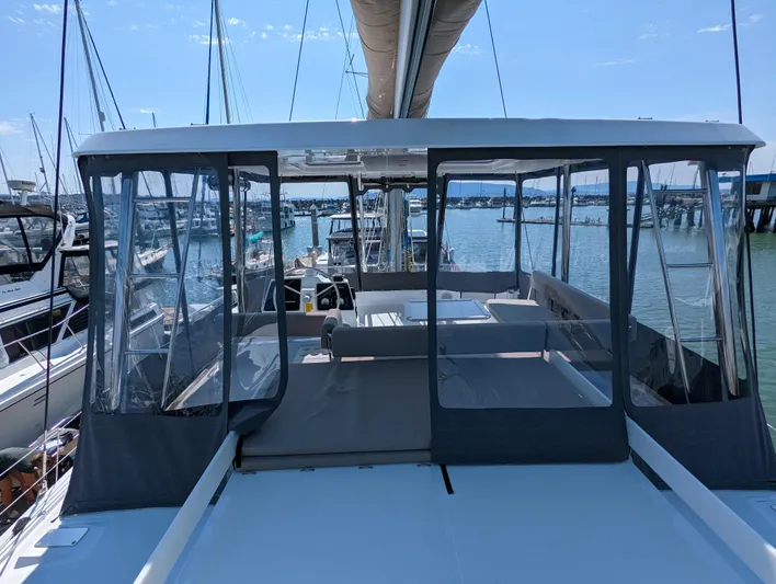 Neve Yacht Photos Pics 2022 Bali 4.6 catamaran with enclosed cockpit, docked at marina.