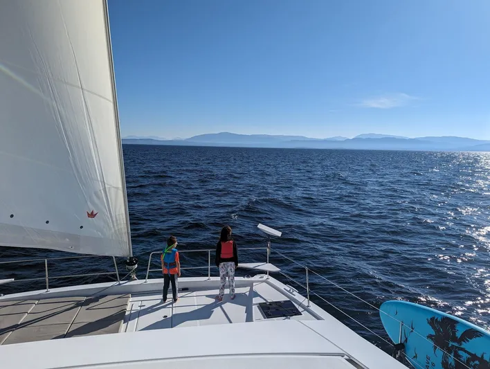 Neve Yacht Photos Pics Two people on a Bali 4.6 catamaran sailing in open sea, 2022 model.