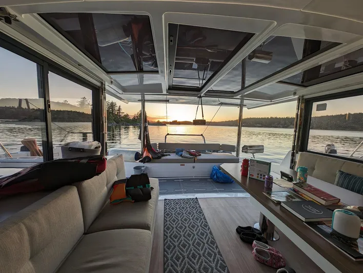 Neve Yacht Photos Pics Interior of 2022 Bali 4.6 catamaran with sunset view over water.