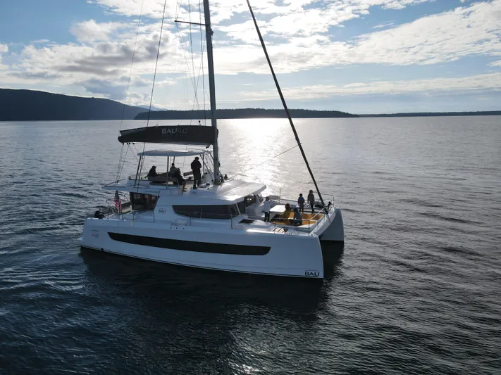 Neve Yacht Photos Pics Sailing catamaran Bali 4.6, 2022 model, cruising on calm waters under a partly cloudy sky.