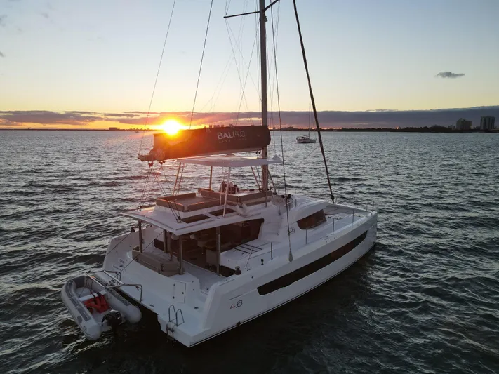 Neve Yacht Photos Pics Bali 4.6 catamaran sailing at sunset, 2022 model, on open water.